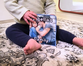 May include: A personalized photo pillow featuring a family portrait. The pillow displays the text "Isabella's Family" in a playful font. The image shows a family of three, with a man and a young girl smiling.