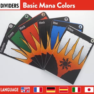 May include: A set of card dividers labelled "DIVIDERS Basic Mana Colors." Each card is a different colour: colourless, green, black, red, blue, and white. The cards have a black border and a sunburst design.