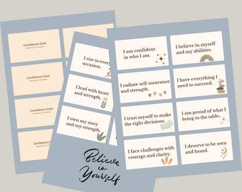 May include: A collection of confidence cards with affirmations. The cards are light beige with text and small illustrations. The phrase "Believe in Yourself" is written in cursive on a light blue background. The cards include phrases like "I am confident in who I am."