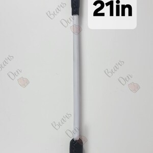 Könnte beinhalten: Eine schwarze, lederummantelte Reitpeitsche, ca. 53 cm lang, mit genähtem Griff und abgerundeter Spitze. Die Peitsche hat einen weißen Schaft. Das Bild enthält den Text "21in".