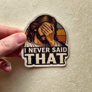 May include: A sticker featuring an illustration of a person with long hair and a beard, covering their eyes with their hand. The text "I NEVER SAID THAT" is displayed in bold, black letters.