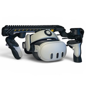 May include: A white and black virtual reality headset with two matching controllers attached to a black rifle-style gun stock accessory. The gun stock features a long top rail and yellow hazard stripes, while the headset has three front sensors.