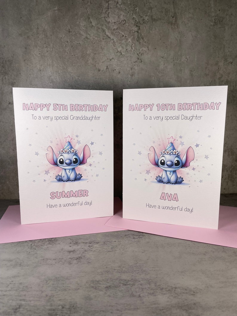 May include: Two birthday cards featuring a blue cartoon character wearing a party hat. The card on the left says "Happy 5th Birthday" and "Summer" with a pink background. The card on the right says "Happy 10th Birthday" and "Ava" with a pink background.