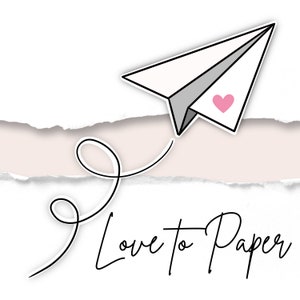 May include: A white paper airplane with a pink heart flies over a torn piece of paper with the text "Love to Paper".