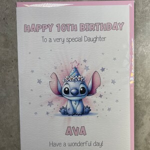 May include: A pink birthday card with a blue cartoon character wearing a party hat and a flower crown. The card says "Happy 10th Birthday" and "To a very special Daughter". The card also says "AVA" and "Have a wonderful day!"