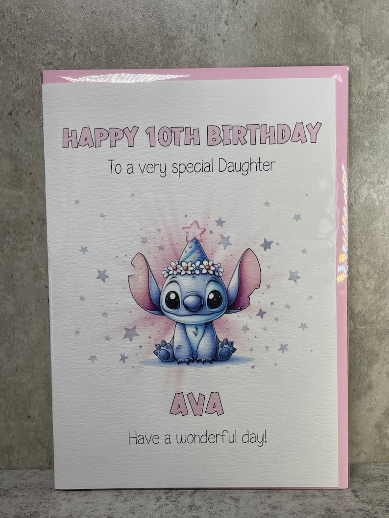 May include: A pink birthday card with a blue cartoon character wearing a party hat and a flower crown. The card says "Happy 10th Birthday" and "To a very special Daughter". The card also says "AVA" and "Have a wonderful day!"
