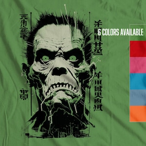 May include: A green t-shirt with a black and white illustration of a zombie face. The illustration is surrounded by Japanese text. The text reads "Year of the Zombie". The t-shirt has 6 colors available.
