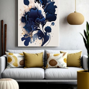 May include: Abstract art print featuring a blue and white floral design with gold accents. The print is framed and hanging on a white wall above a gray couch with yellow and brown pillows.