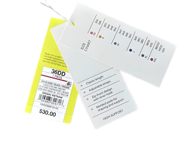 Puede incluir: Una etiqueta blanca con una tabla de tallas y detalles del producto, incluyendo "36DD" y "HIGH SUPPORT". La etiqueta tambi&eacute;n enumera caracter&iacute;sticas como correas ajustables y un dise&ntilde;o con cremallera frontal con gancho interno.