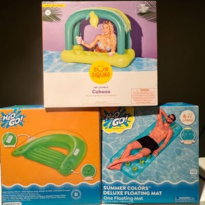 May include: Three boxes of inflatable pool floats. The top box features a cabana with a woman inside. The middle box shows a green pool float with handles. The bottom box displays a blue floating mat with a man on it. The boxes have the text "Sun Squad" and "H2O Go!"