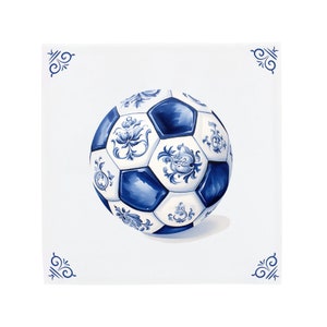 May include: A white football with blue and white floral designs. The ball is on a white background with blue corner designs.