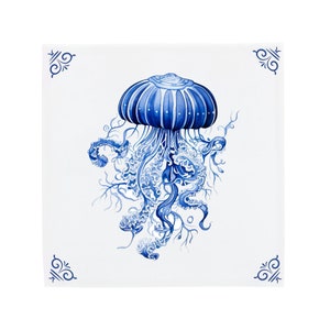 May include: A blue and white ceramic tile with a detailed illustration of a jellyfish with flowing tentacles.