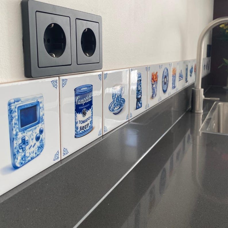 a row of blue and white tiles on a wall