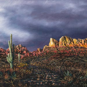 May include: An original landscape painting of a desert scene. The artwork depicts a path leading towards red rock formations under a dramatic, dark, cloudy sky. A tall cactus stands in the foreground, with other desert plants and flowers.