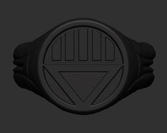 May include: Black ring with a black and white symbol. The symbol is a circle with a triangle inside and lines across the top.