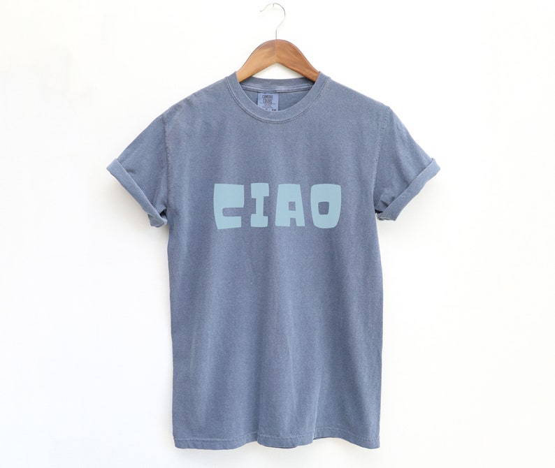 May include: A gray t-shirt with a light blue "CIAO" graphic printed on the front.
