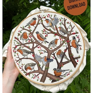 May include: Embroidered hoop art featuring a white fabric with a brown tree branch design. The tree branches are adorned with red berries and 12 embroidered robins in various poses.