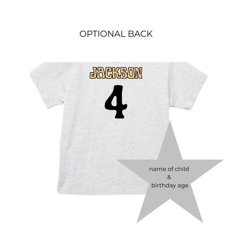 May include: A light gray t-shirt with the name "JACKSON" in a gold and black font above a large black number "4". The words "OPTIONAL BACK" are above the shirt. A gray star graphic is on the right.