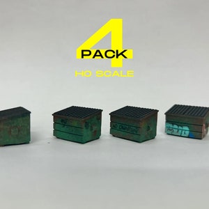 May include: Four green metal dumpsters with black lids and graffiti. The dumpsters are in HO scale. The text "4 PACK HO SCALE" is visible above the dumpsters.
