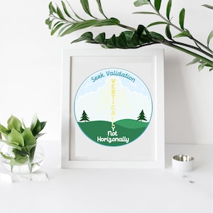 May include: A framed art print with a white border. The circular graphic features a green landscape with two pine trees, a blue sky, and the text "Seek Validation Vertically Not Horizontally."