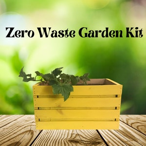 May include: A yellow wooden crate with a green plant growing inside. The crate is labeled "Zero Waste Garden Kit".