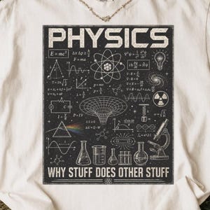 May include: White t-shirt with a black graphic featuring the word "PHYSICS" and scientific diagrams. The graphic includes equations, an atom model, and the text "WHY STUFF DOES OTHER STUFF".