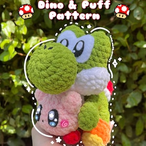 May include: A green crocheted Yoshi plush toy with white eyes and a pink crocheted puff ball with a pink swirl on its face. The Yoshi is holding the puff ball in its arms. The text "Dino & Puff Pattern" is written above the toys.