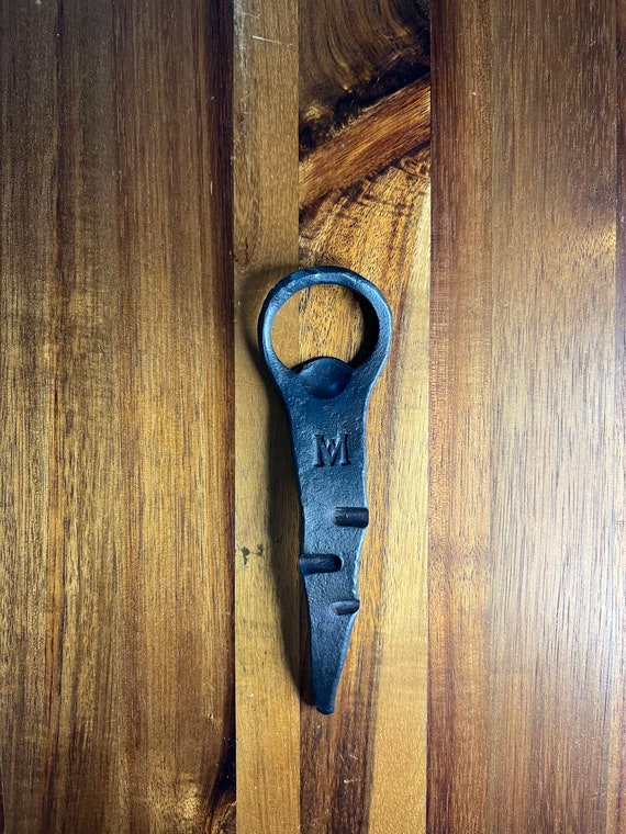 Actually hand-forged at an anvil by a blacksmith — the organic hammer marks make every single opener completely one-of-a-kind.