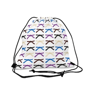 May include: White drawstring bag with a repeating pattern of colorful martial arts belts tied in a knot. The belts are in shades of blue, purple, brown, black, and white.