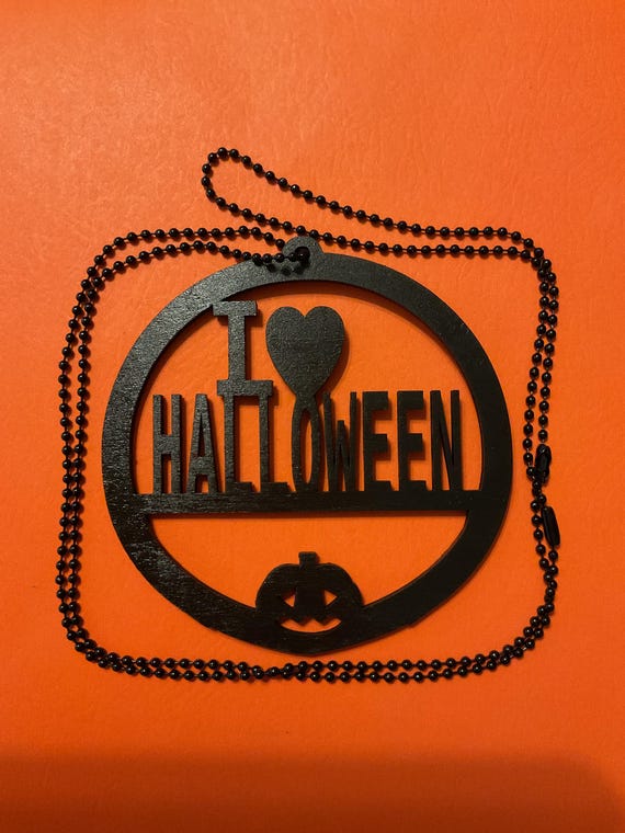 Matte black laser-cut I love Halloween round pendant on a black ball chain
