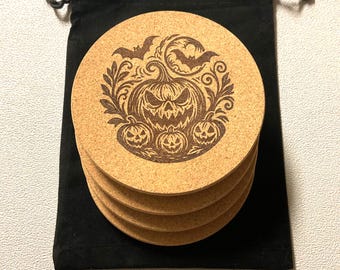 Set of four cork coasters laser etched with spooky pumpkin Halloween designs