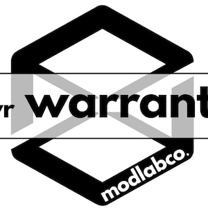 May include: Black and white graphic with the text "2yr warranty" over a geometric shape. The brand name "modlabco." is at the bottom of the shape. The design is simple and modern.