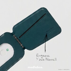 May include: Teal leather wallet with a magnetic money clip. The wallet is open, revealing a card slot and the text "Engrave Your Name!!". The brand name "Modlabco" is at the bottom.