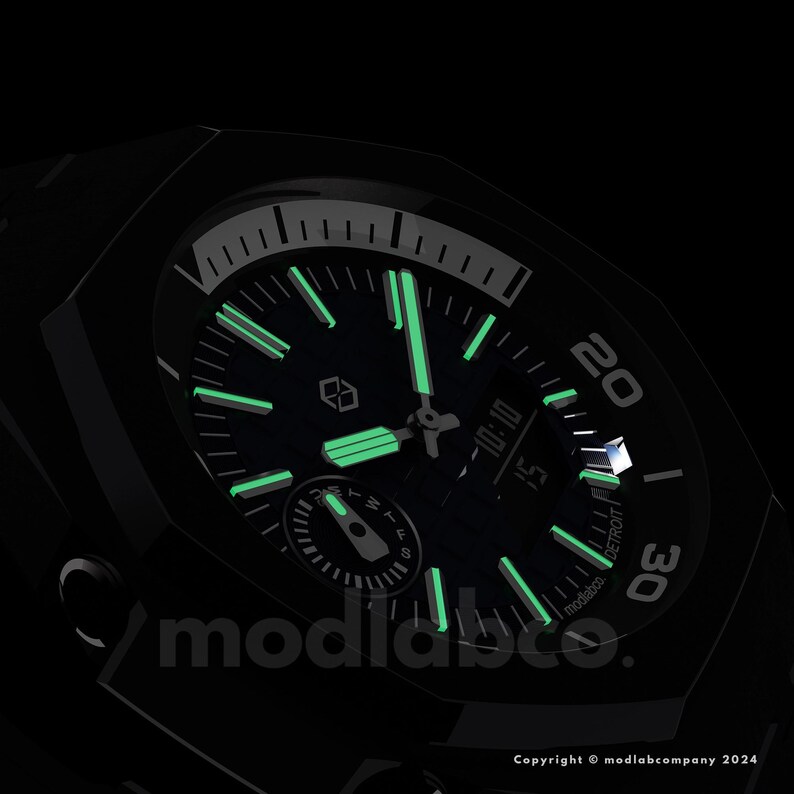 May include: Black wristwatch with a dark green face and glowing green hands and markers. The watch face displays the time as 10:10 and the word "DETROIT". The watch has the text "modlabco." and "Copyright &copy; modlabcompany 2024".