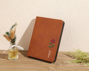May include: A brown leatherette journal with a rose and the word "Galina" embroidered on the front.