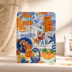 May include: A decorative tablet case with a collage design featuring orange slices, a can of tomatoes, and a goldfish. The design incorporates blue and white patterns, a starfish, and the word "PAR".