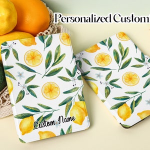 May include: A white e-reader cover with a lemon and leaf pattern. The cover has the text "Custom Name" printed on it.  Personalized Customization.