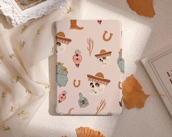 May include: A pink and white patterned phone case with a skull wearing a sombrero, a cactus, a horseshoe, a heart, and a bottle of tequila.