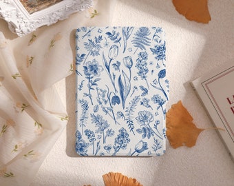 May include: A white and blue floral patterned case for an e-reader. The case has a blue floral design with tulips, ferns, and other flowers.