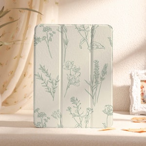May include: A white iPad case with a floral pattern in green. The case has a textured surface and a subtle sheen.