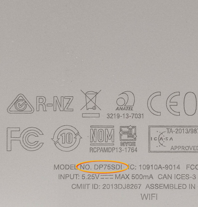 May include: Close-up of a white device with various certifications and regulatory markings, including FCC, IC, CMIIT, NOM, and CE. The model number is DP75SDI. The text "INPUT: 5.25V MAX 500mA" is also visible.