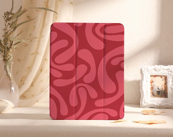 May include: A red tablet case with a pink abstract swirl pattern.