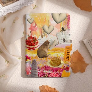 以下が含まれることがあります： 猫、ケーキ、チケット、ハート、本が描かれたカラフルなコラージュ。背景は黄色とピンクの水彩画で描かれている。