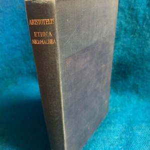 May include: A blue hardcover book with gold lettering on the spine. The title is "ARISTOTELIS ETHICA NICOMACHEA".