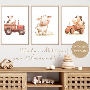 May include: Three framed watercolor prints featuring farm animals. One print shows a cow and pig in a red tractor, another a cow in a field, and the third a cow and calf in a tractor. The text "Als Set oder Einzelposter" is visible.