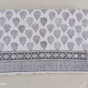 May include: White cotton quilt with a gray leaf pattern and a gray and white geometric border.