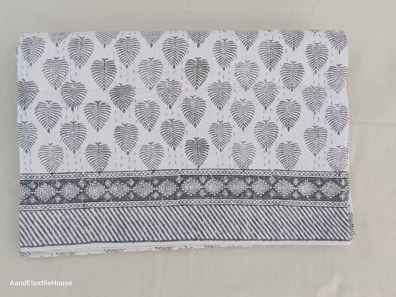 May include: White cotton quilt with a gray leaf pattern and a gray and white geometric border.