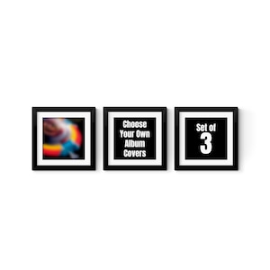 three black and white posters on a white wall