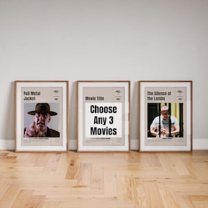 May include: Three movie poster prints in brown frames. The posters are for the films "Full Metal Jacket", "The Silence of the Lambs", and a blank poster that says "Choose Any 3 Movies".