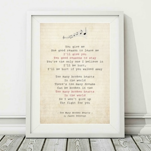 May include: A vintage-style print of song lyrics for the song "Too Many Broken Hearts" by Jason Donovan. The lyrics are printed in black text on a cream-coloured background with musical notes at the top.